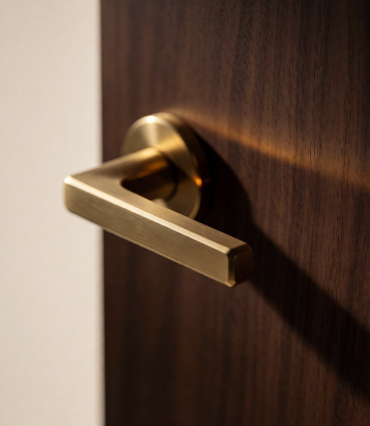 Brass door handle on dark wood representing the Anatra luxury real estate case study